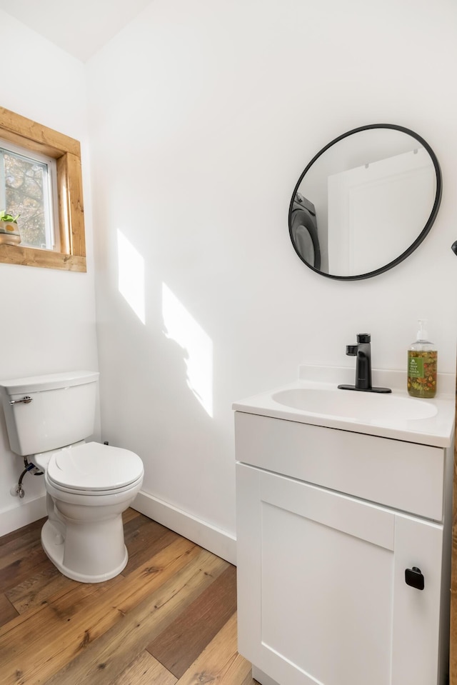 bathroom featuring vanity, hardwood / wood-style floors, and toilet