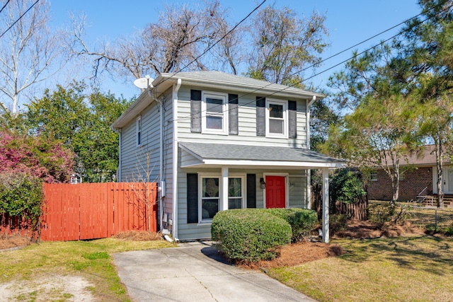 view of front of property with fence and a front lawn