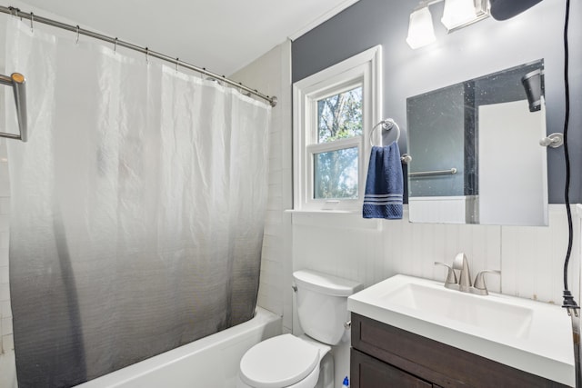 bathroom featuring toilet, shower / bath combination with curtain, and vanity