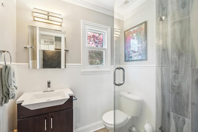 full bath featuring toilet, a wainscoted wall, ornamental molding, vanity, and a shower stall