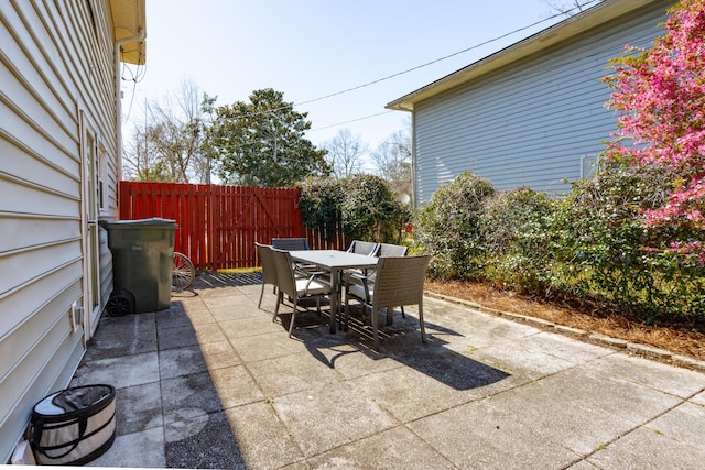 view of patio / terrace featuring outdoor dining area and fence