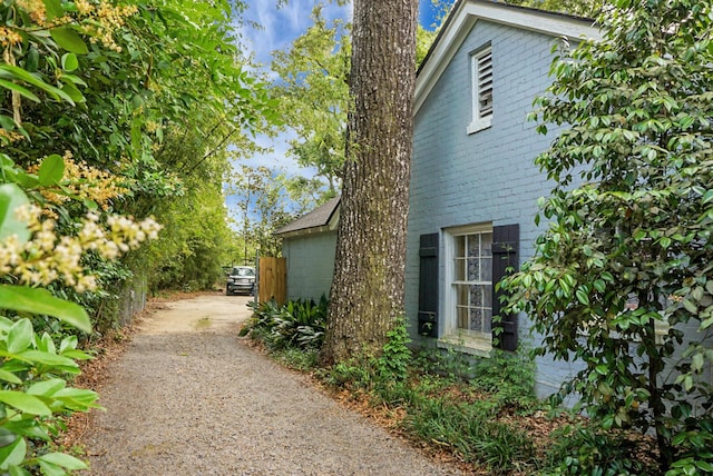 view of home's exterior with dirt driveway