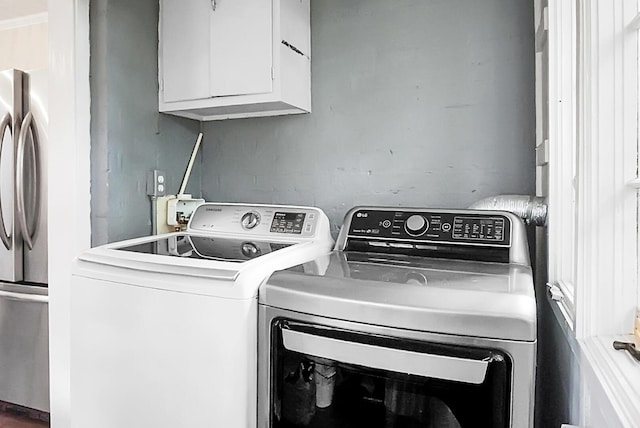laundry area with cabinet space and washing machine and dryer