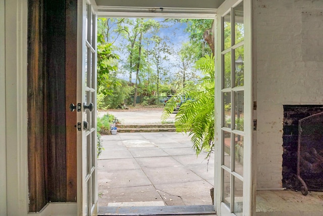 entryway with french doors and a fireplace