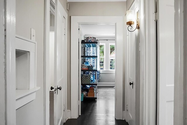 hall with baseboards and dark wood-style floors