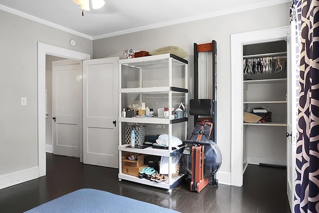 bedroom with crown molding, wood finished floors, and baseboards