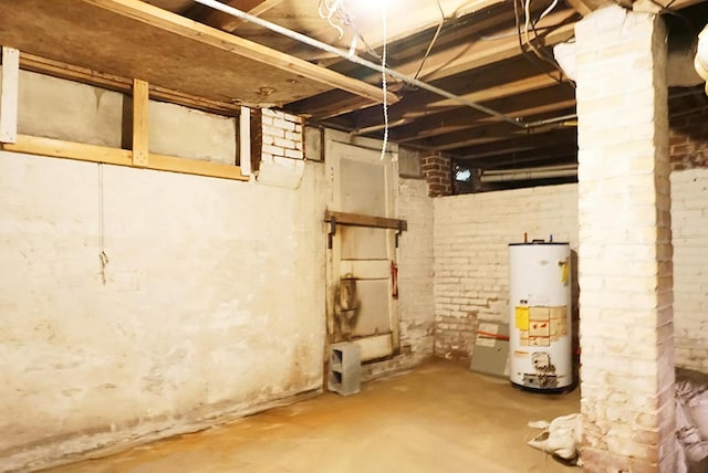 unfinished basement featuring water heater