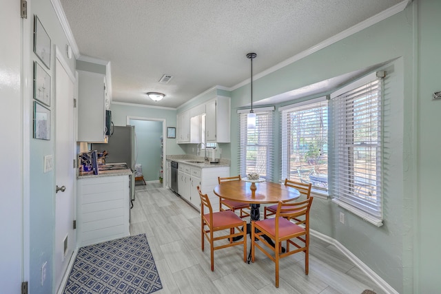 dining space with baseboards, visible vents, crown molding, and a textured ceiling