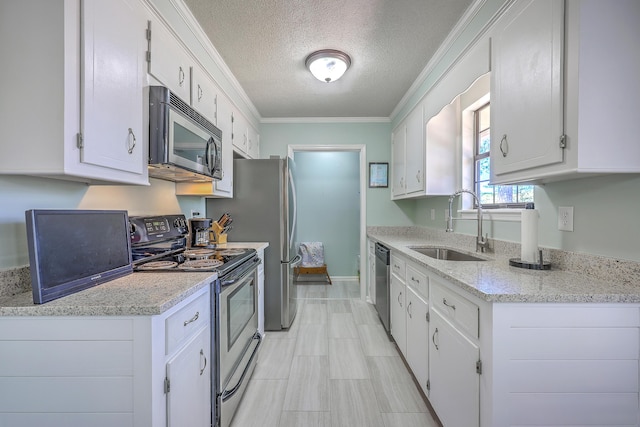 kitchen featuring white cabinets, a sink, appliances with stainless steel finishes, and crown molding