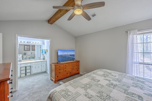 bedroom with connected bathroom, a sink, light carpet, vaulted ceiling with beams, and visible vents