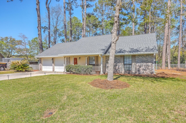 view of front of property featuring a front yard, concrete driveway, fence, and an attached garage