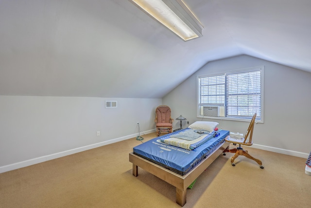 interior space featuring baseboards, visible vents, and vaulted ceiling