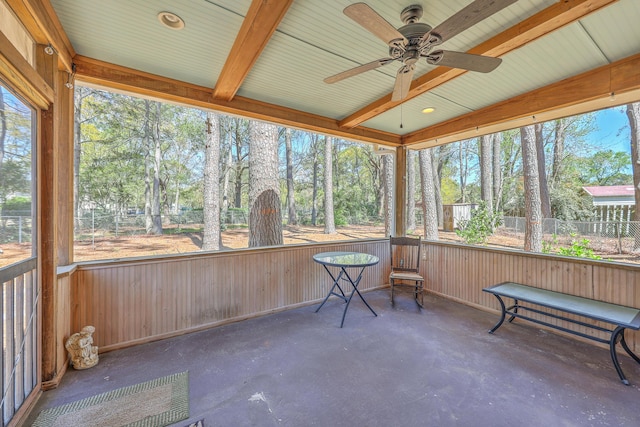 sunroom / solarium featuring beam ceiling and ceiling fan