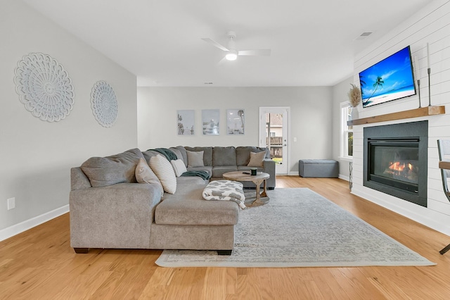 living room featuring hardwood / wood-style floors and ceiling fan