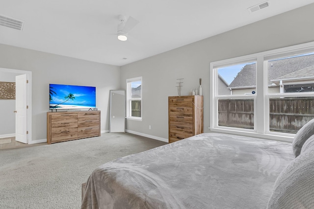 carpeted bedroom featuring multiple windows and ceiling fan