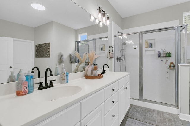 bathroom featuring vanity and a shower with shower door