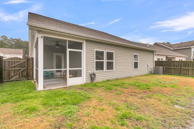 back of house with central AC, a sunroom, and a yard