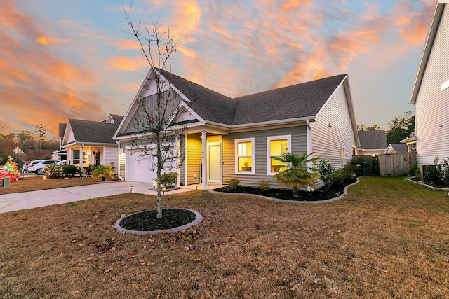 view of front of home featuring central AC, a yard, and a garage