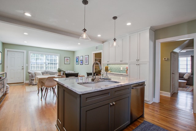 kitchen with dishwasher, a sink, white cabinetry, and light wood-style floors