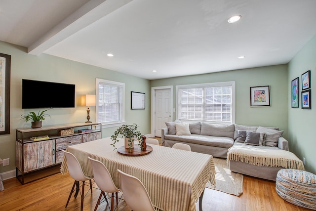 living room with baseboards, light wood finished floors, beam ceiling, and recessed lighting