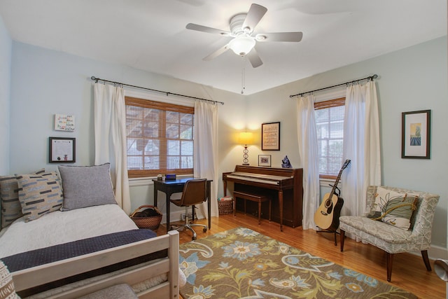 living area with ceiling fan and wood finished floors