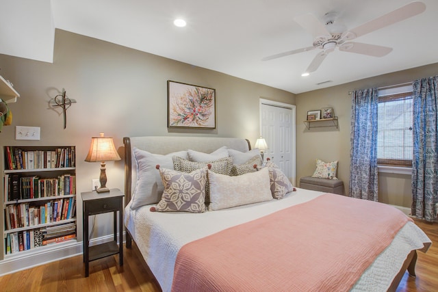 bedroom featuring recessed lighting, a ceiling fan, a closet, and wood finished floors