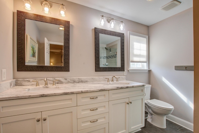 full bath with toilet, tiled shower, a sink, and visible vents