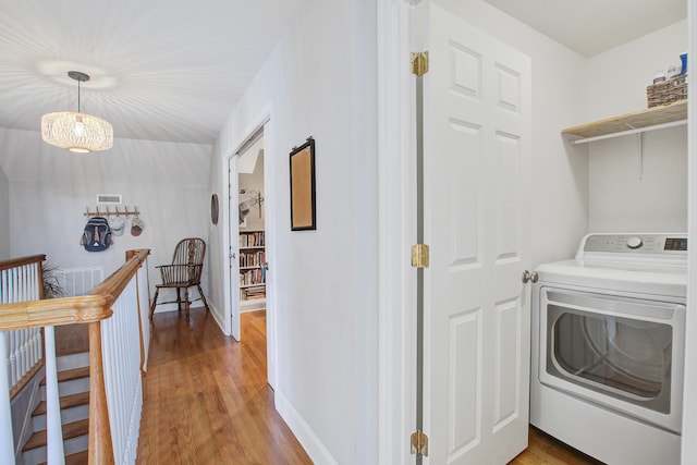 laundry room featuring laundry area, light wood-style flooring, and washer / clothes dryer