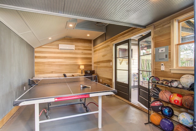 recreation room with concrete floors, wooden walls, vaulted ceiling, and a wall mounted air conditioner