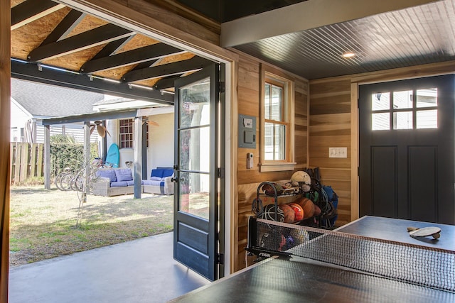 interior space featuring wooden walls and concrete flooring