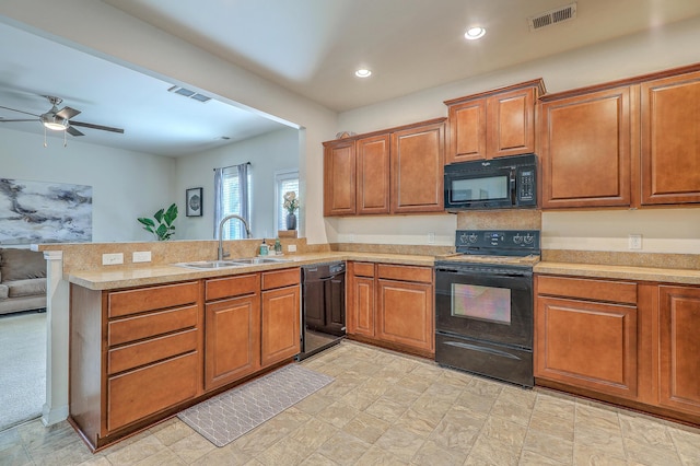 343 Iveson Rd, Summerville, SC 29486 - kitchen with a sink, a peninsula, brown cabinets, visible vents, and black appliances