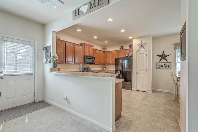 343 Iveson Rd, Summerville, SC 29486 - kitchen featuring light countertops, a peninsula, recessed lighting, black appliances, and brown cabinetry