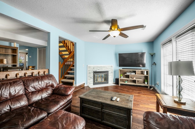 1101 Reserve Way, Summerville, SC 29485 - living room featuring ceiling fan, a stone fireplace, a textured ceiling, and hardwood / wood-style flooring