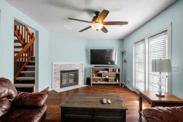 1101 Reserve Way, Summerville, SC 29485 - living room with a textured ceiling, ceiling fan, dark hardwood / wood-style floors, and a stone fireplace