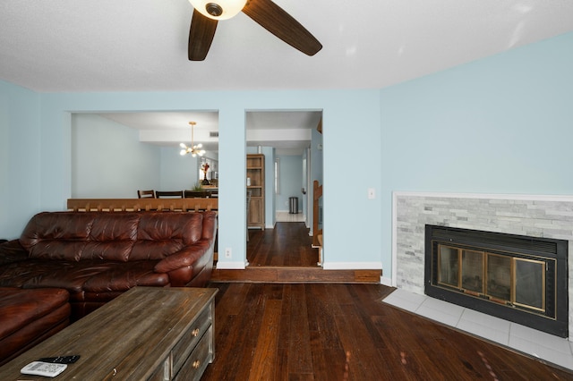 1101 Reserve Way, Summerville, SC 29485 - living room featuring a tiled fireplace, dark wood-type flooring, and ceiling fan with notable chandelier