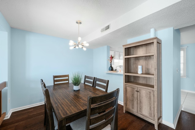1101 Reserve Way, Summerville, SC 29485 - dining room featuring dark wood-type flooring, a textured ceiling, and an inviting chandelier