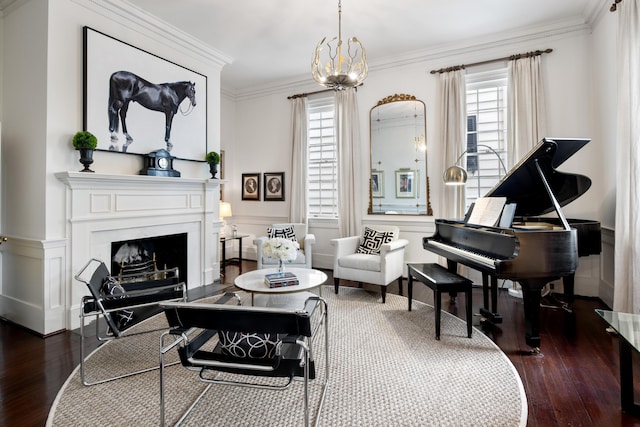 living area featuring ornamental molding, dark wood-type flooring, and an inviting chandelier