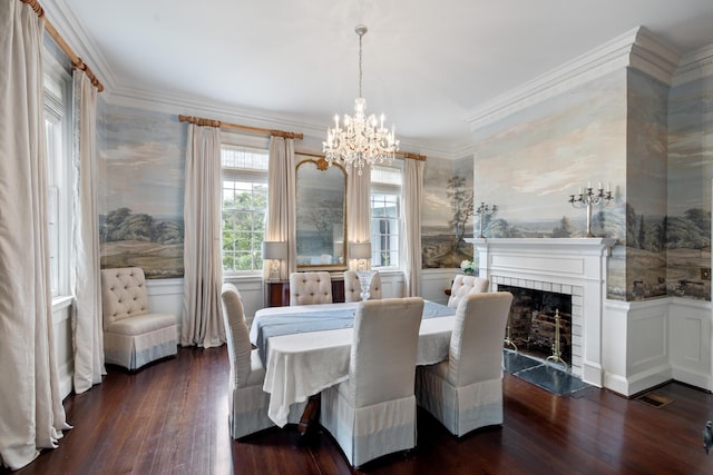 dining area featuring an inviting chandelier, crown molding, and dark hardwood / wood-style flooring