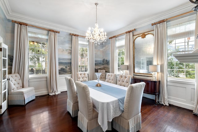 dining room with ornamental molding, dark wood-type flooring, and an inviting chandelier