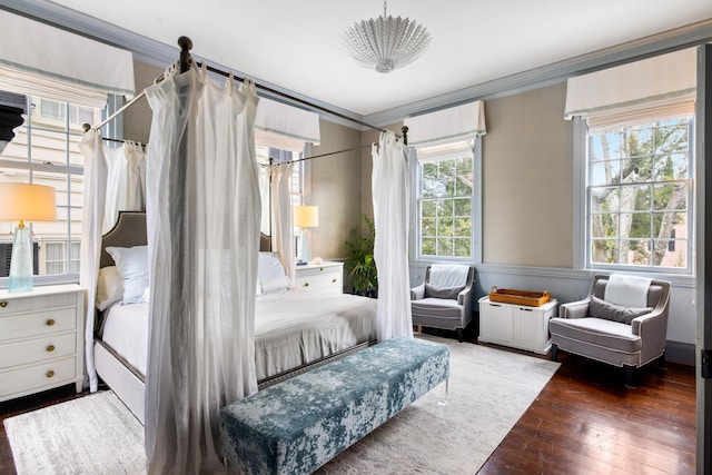 bedroom featuring ornamental molding and hardwood / wood-style floors