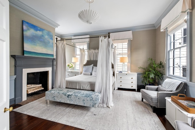 bedroom with crown molding and dark hardwood / wood-style flooring