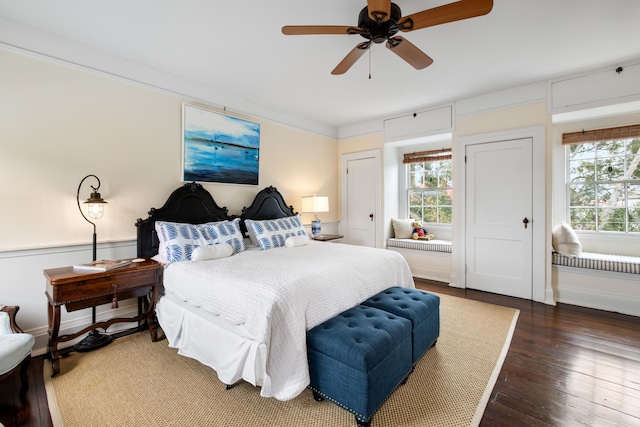 bedroom with dark hardwood / wood-style floors and ceiling fan