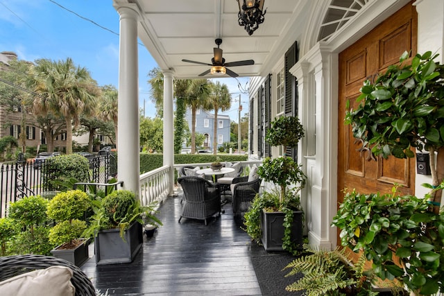 wooden terrace with a porch and ceiling fan