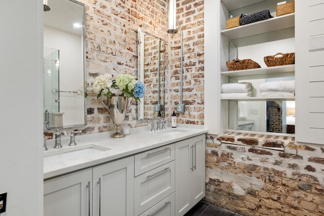 bathroom featuring brick wall, vanity, and an enclosed shower