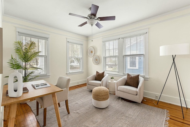 office area featuring baseboards, wood finished floors, and ornamental molding