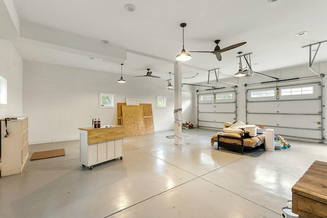 garage with a garage door opener and ceiling fan