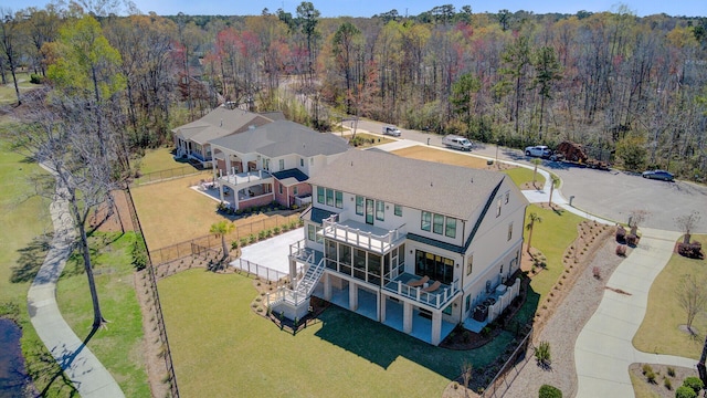 birds eye view of property featuring a view of trees