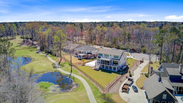 birds eye view of property with a water view and a forest view