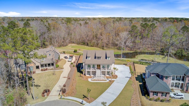 birds eye view of property with a wooded view