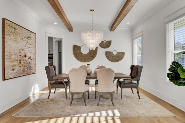dining area featuring beam ceiling, a chandelier, wood finished floors, baseboards, and ornamental molding